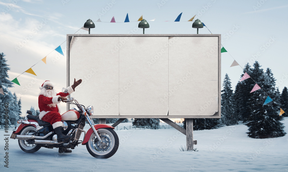 Obraz premium Biker Santa Claus and blank advertising board