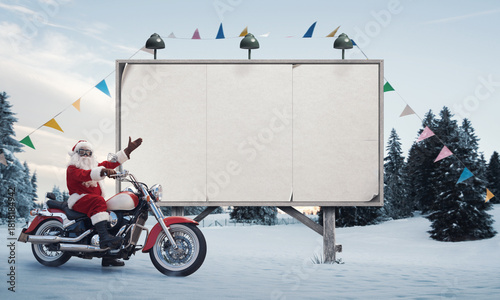 Biker Santa Claus and blank advertising board