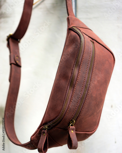 Tableau sur toile Brown leather waist bag hanging on the wall
