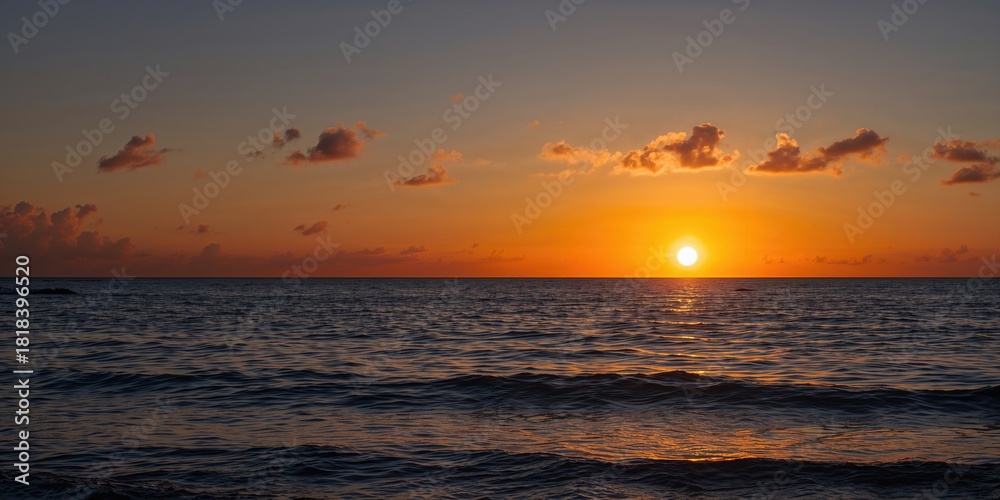 Fototapeta premium Sunset over the sea with vibrant sky, waves, and clouds, emphasizing natural beauty
