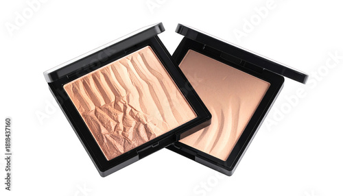 Two open compacts of pressed powder, one textured, on a black backdrop