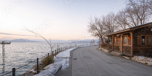 Fototapeta Naklejka Na Ścianę i Meble -  Empty streets and a lakeside restaurant in winter in Epirus, Greece, with a focus on seasonal tourism
