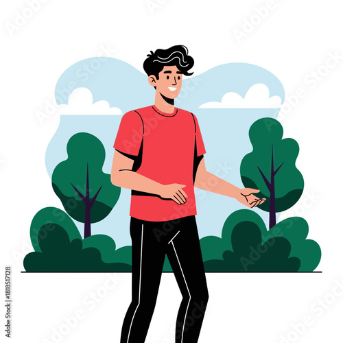 Happy young man in a red shirt and black trousers standing in a pleasant outdoor park environment with foliage