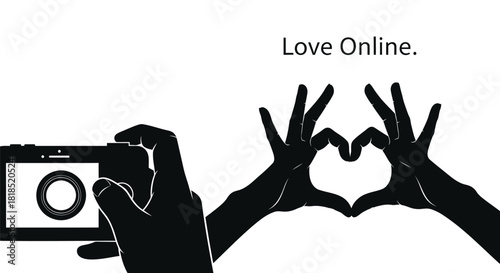 Silhouette of hands forming a heart shape while holding a camera symbolizing online love and connection