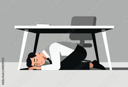 A person in a business suit is taking shelter under a desk, appearing to brace for impact