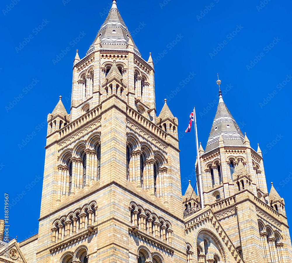 Fototapeta premium Towering spires of the Natural History Museum rise into clear summer skies in London, UK
