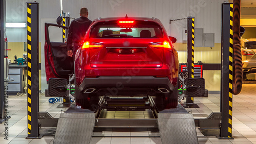 Car on stand with sensors on wheels for wheels alignment camber check in workshop of Service station timelapse.