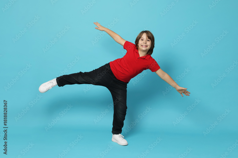 Obraz premium Full length portrait of cute boy on light blue background