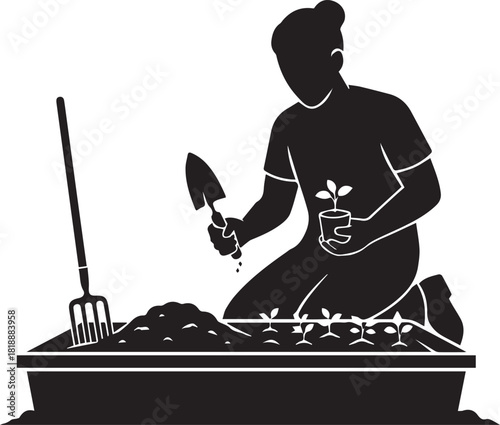 Silhouette of a gardener planting seedlings in a raised garden bed with tools
