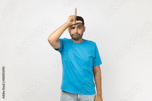 Upset bored unshaven man showing looser gesture, having depression, being sad, expressing sorrow.