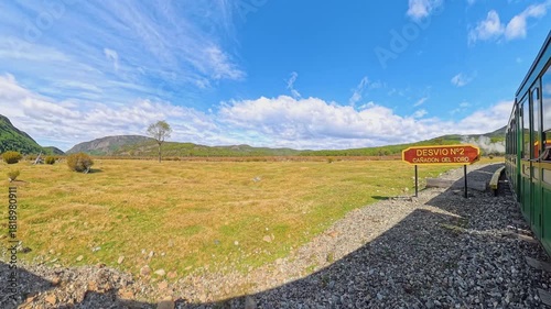 A historical steam locomotive winds through Tierra del Fuego National Park in Ushuaia, Argentina, offering a glimpse into the past as it follows tracks built by prisoners.