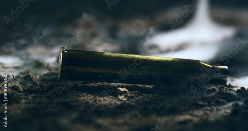 Slow Motion Close Up Of Spent Bullet Shells Sinking Into Dry Ground With Floating Dust Particles And Warm Low Light Cinematic Atmosphere, Concept Of Violence, Consequences, Human Conflict, Destruction