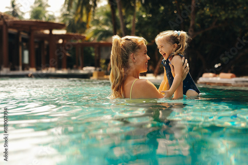 Mother and daughter enjoying a luxurious vacation swimming together