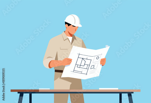 A construction worker in beige uniform, white hardhat, examines blueprints at a wooden table against a blue background