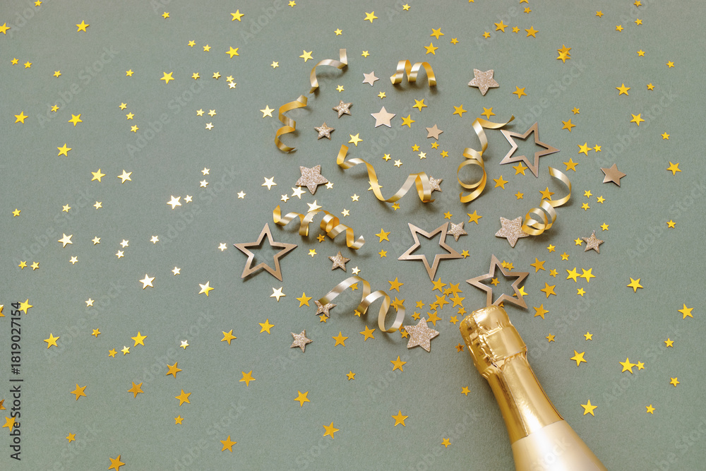 Obraz premium Party, New Year or birthday festive background with golden champagne bottle and confetti stars. Trendy green card for holiday celebration top view.