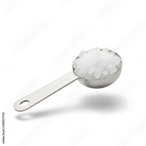 Metal Measuring Spoon Holding Sea Salt Crystals Isolated on White