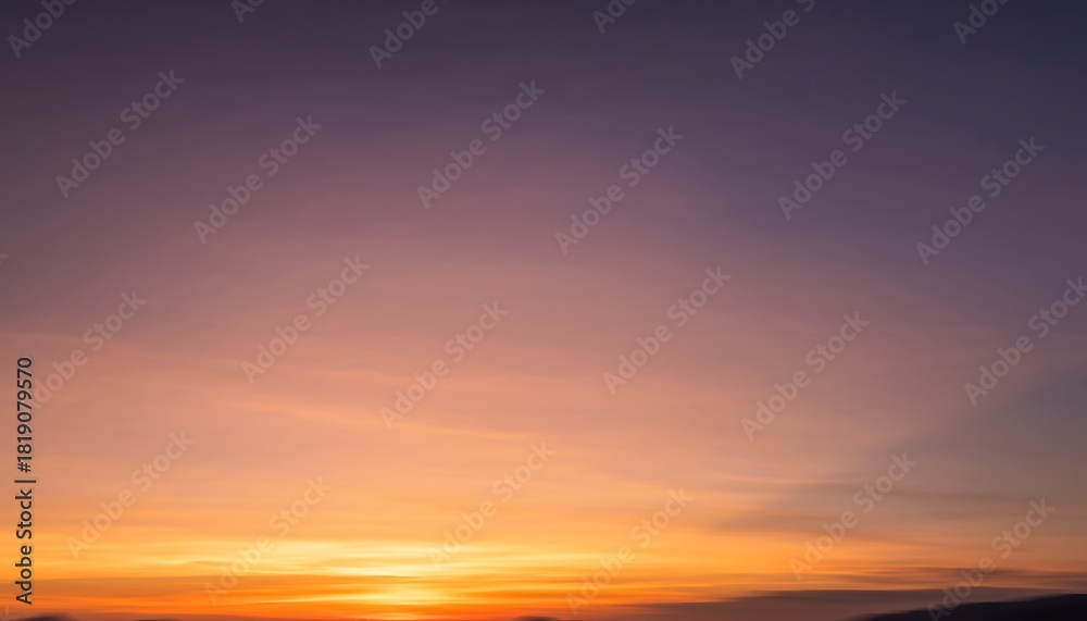 Fototapeta premium Bright colorful sky during sunset, fully blurred into smooth gradient tones, creating a soft and dreamy atmospheric background.