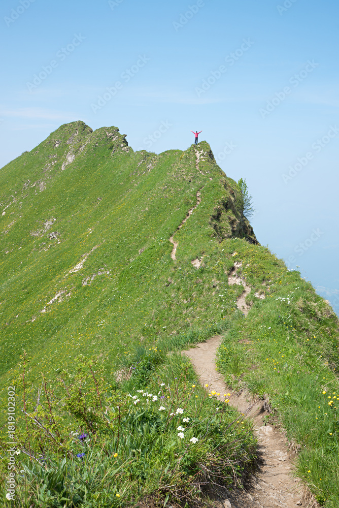 Naklejka premium man with outstretched arms at ridge path to the eastern Hüttenkopf, allgau alps