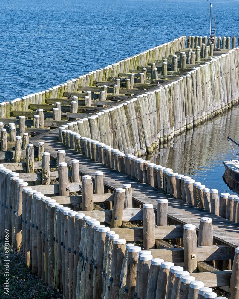 Fototapeta premium breakwaters wooden piles protect the coast