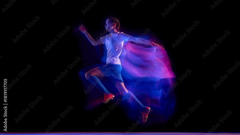 Fototapeta premium Female soccer player sprinting in neon light motion trail. Concept of fitness campaign visuals, sportswear brand advertising, and coaching materials for speed and agility drills.