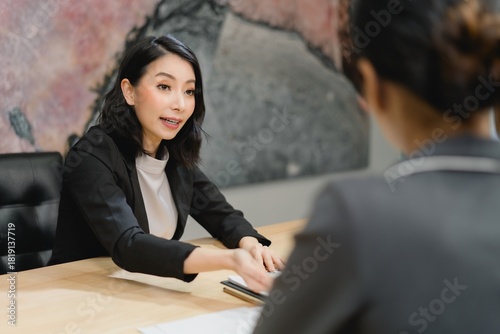 Professional woman delivering persuasive strategic pitch and engaging in active communication during critical consultation or interview