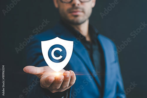 Copyright protection concept man holding shield copyright symbol intellectual property law legal rights 100