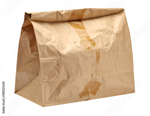 Brown kraft paper lunch bag with visible grease and oil stains soaking through the surface on isolated background