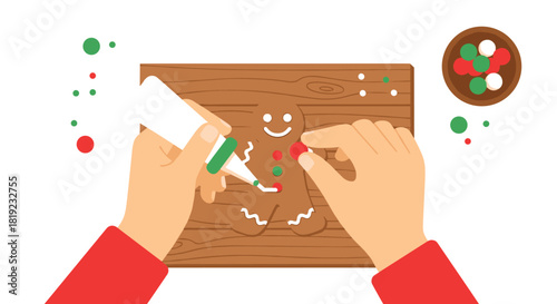 Top-down view of hands decorating a gingerbread man cookie with icing and candy on a wooden cutting board.