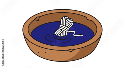 Yarn ball soaking in indigo dye inside a wooden bowl for textile creation.