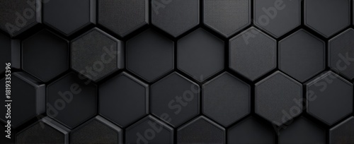 Dark gray honeycomb background of slightly raised, textured hexagons