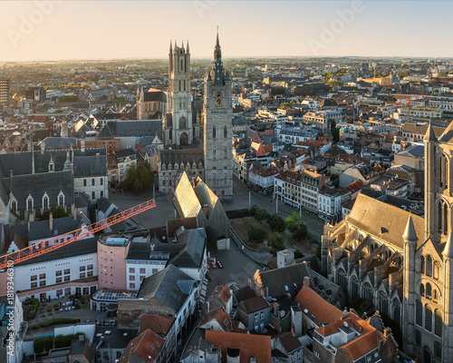 Aerial view of the imposing Saint Nicholas' Church, the iconic Belfry of Ghent, and the dramatic Saint Bavo Cathedral define the Ghent skyline, Flanders, Belgium.
