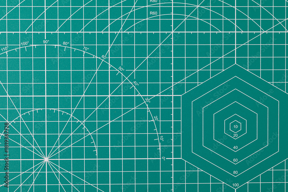 Naklejka premium Green cutting mat surface with grid and measurement lines