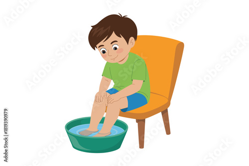 A young boy sits on a chair and soaks his feet in a bowl of water.