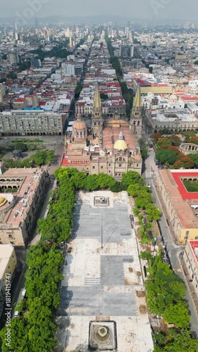 Drone flight advancing over Plaza de la Liberacion showing the Guadalajara Cathedral and historic downtown during renovation