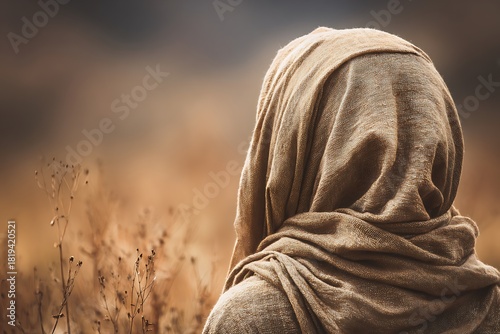 Woman contemplating solitude in barren autumn field