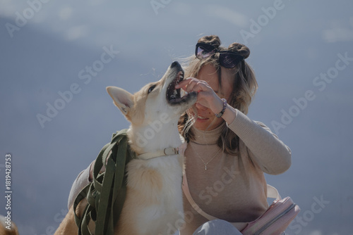 a dog with an open mouth next to a person