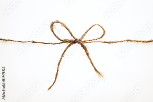 String tied in a bow on a white background