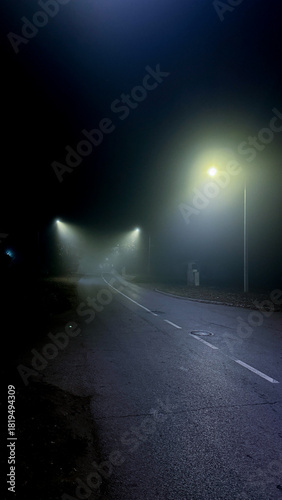 Misty nocturnal road whispers eerie tales, urban solitude, lost stories of Samhain wanderers, liminal space captured in gloom