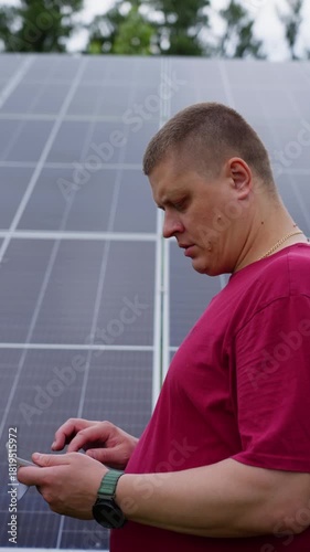 A man checks the electricity production indicators from solar panels. High quality 4k footage