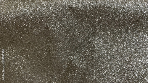 Dark, rich gold and silver glitter texture background with shimmering light and festive glamour