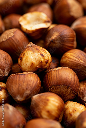 Roasted hazelnuts scattered on a wooden surface create a warm and inviting sight for snack lovers
