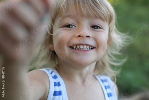 Joyful Child's Bright Smile in Outdoor Setting