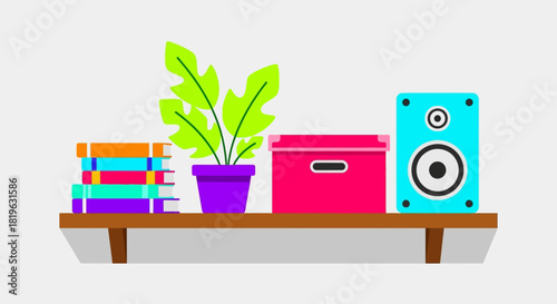 A wooden shelf displays a stack of colorful books, a potted green plant, a pink storage box, and a blue speaker, creating a cozy and organized home decor scene