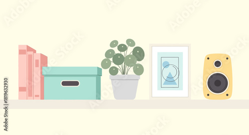 A minimalist shelf displaying decorative items including books, a plant, and a speaker, perfect for home decor concepts
