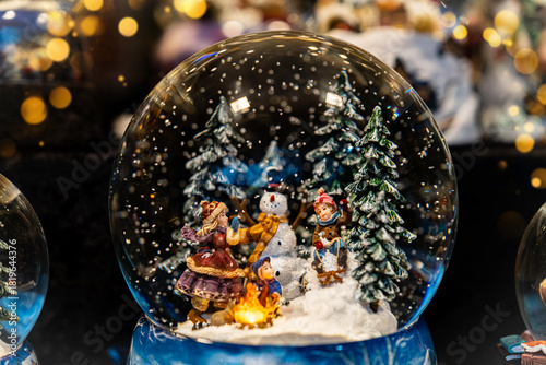 A Christmas snow globe. Christmas market in Europe. The showcase of the store of Christmas and New Year's toys. Winter holidays. Gifts for your loved are here. The Christmas spirit. 2025 