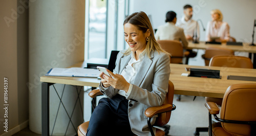 Smiling woman in office che...