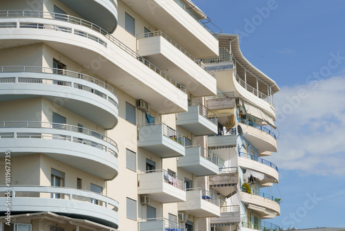 A traditional whitewashed home with blue trim sits near a seashore. Perfect for vacation rentals, regional architecture lovers, AC-ready houses, and affordable seaside property markets.