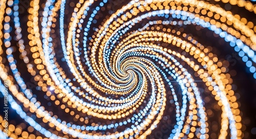 A spiral pattern of orange and blue bokeh lights swirling into the center of the image abstractly