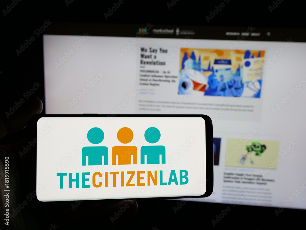 Fototapeta premium Stuttgart, Germany - 11-19-2025: Person holding smartphone with logo of Canadian research laboratory Citizen Lab on screen in front of website. Focus on phone display.