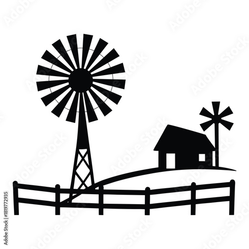 Rustic ranch windmill with a fence line and open landscape